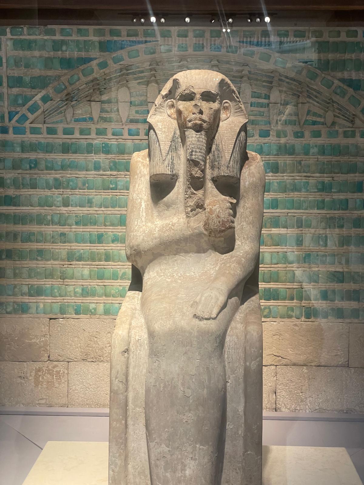 Before the seated statue of Djoser.