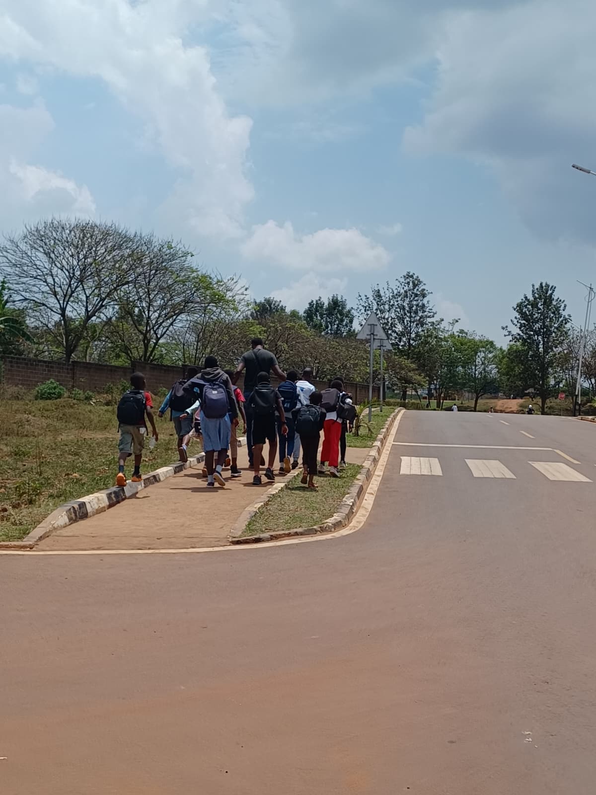 Walking the children down the road to school.