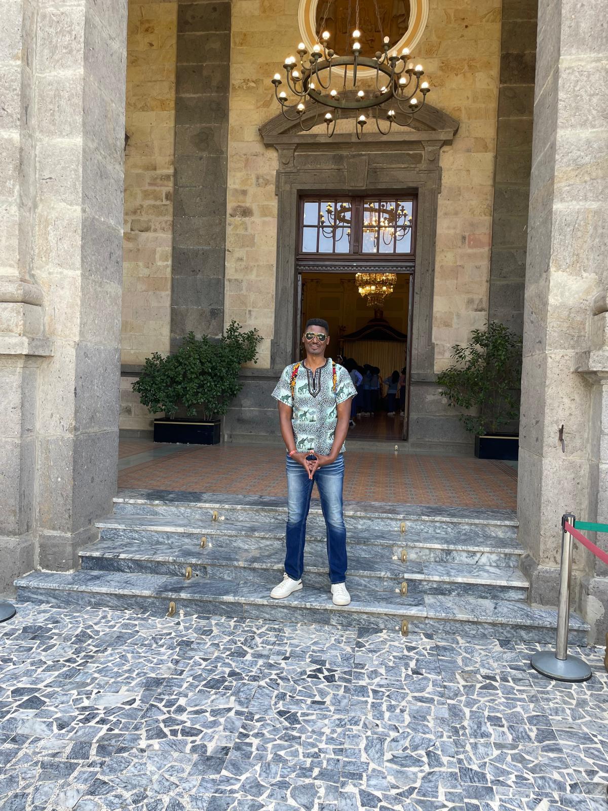 On the steps of the palace.